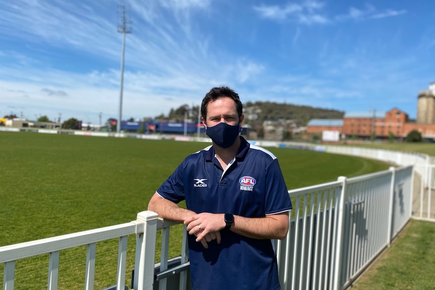 AFL manager standing near the field at Robertson Oval in Wagga Wagga