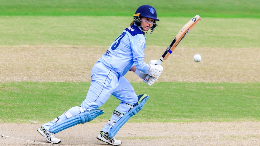 Horley hits the ball to her right hand side and watches it in the air as she takes off for a run