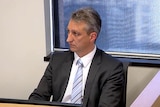 A mid-shot of Lonnie Bossi giving evidence at the Perth Casino Royal Commission.