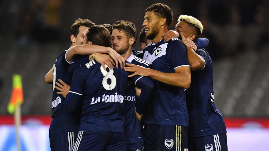 Seven Melbourne Victory A-League players celebrate a goal against Western Sydney Wanderers.