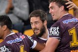 Brisbane Broncos celebrate a try against the Knights