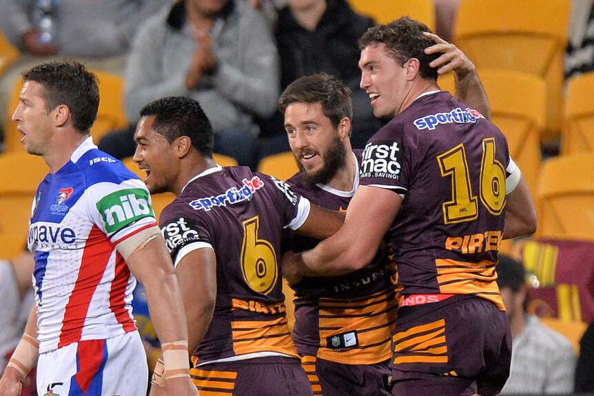 Brisbane Broncos celebrate a try against the Knights