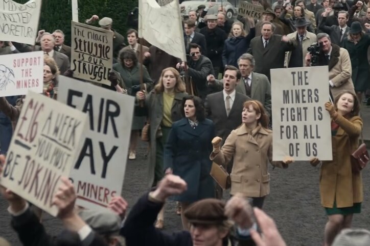 A group of protesters in the 70s holding signs that say 'the miners fight is for all of us'.