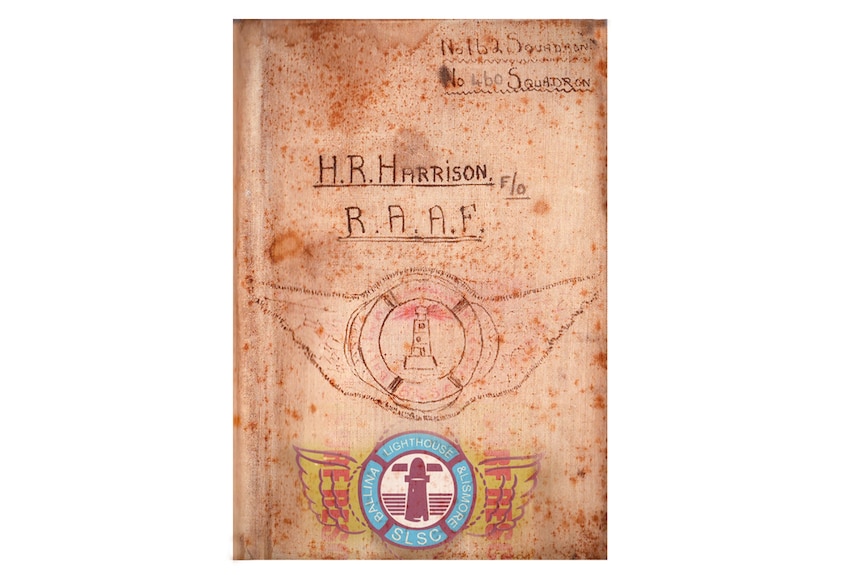 Front cover of a notebook with H. R. Harrison R.A.A.F written on it with a drawing of a lighthouse within the outline of wings.