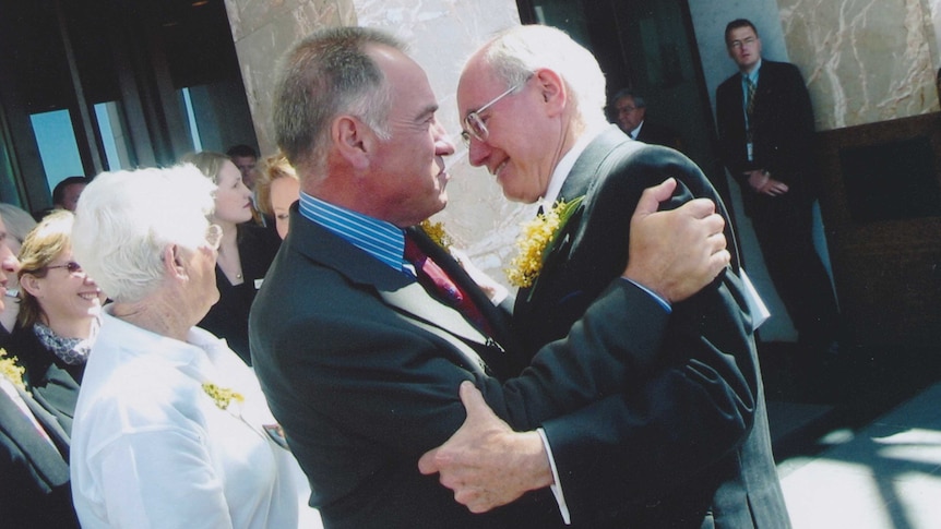 Former prime minister John Howard embraces Bill Hardy