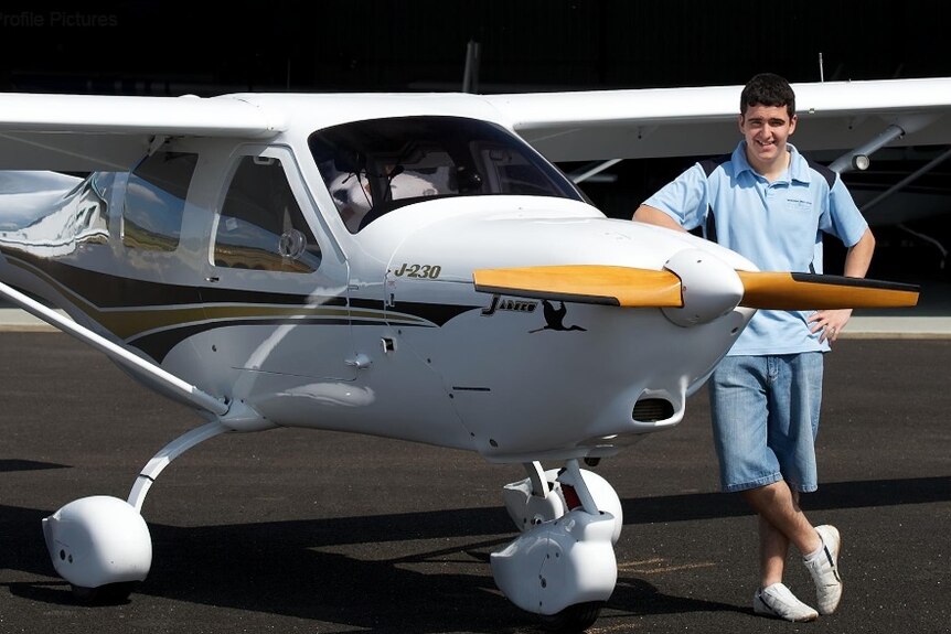 Nathan Parker standing by a small plane before the accident.