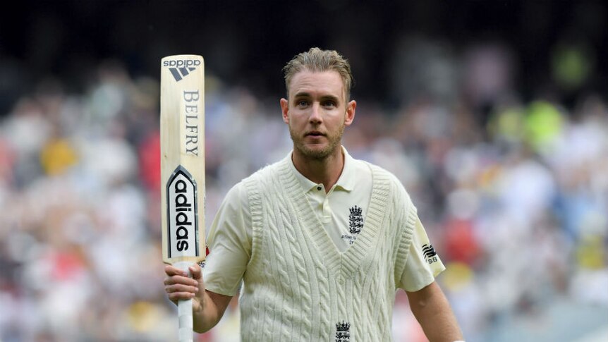 Stuart Broad walks off and raises his bat after making 56 runs