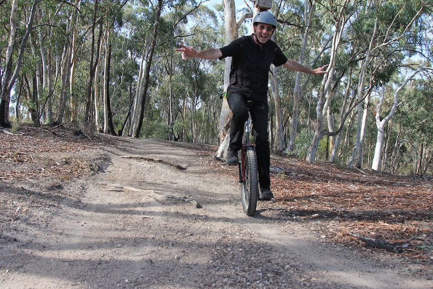 Rob Armstong riding a unicycle down a mountain