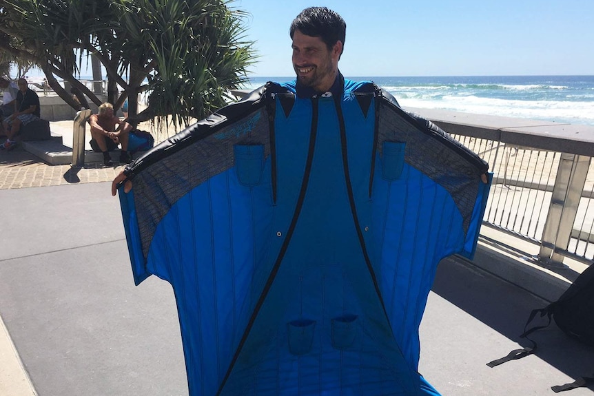 Wingsuit flyer Luke Rogers kitted up on the beachfront at Surfers Paradise