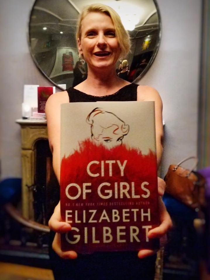 Elizabeth Gilbert holding a copy of her new book, City of Girls.