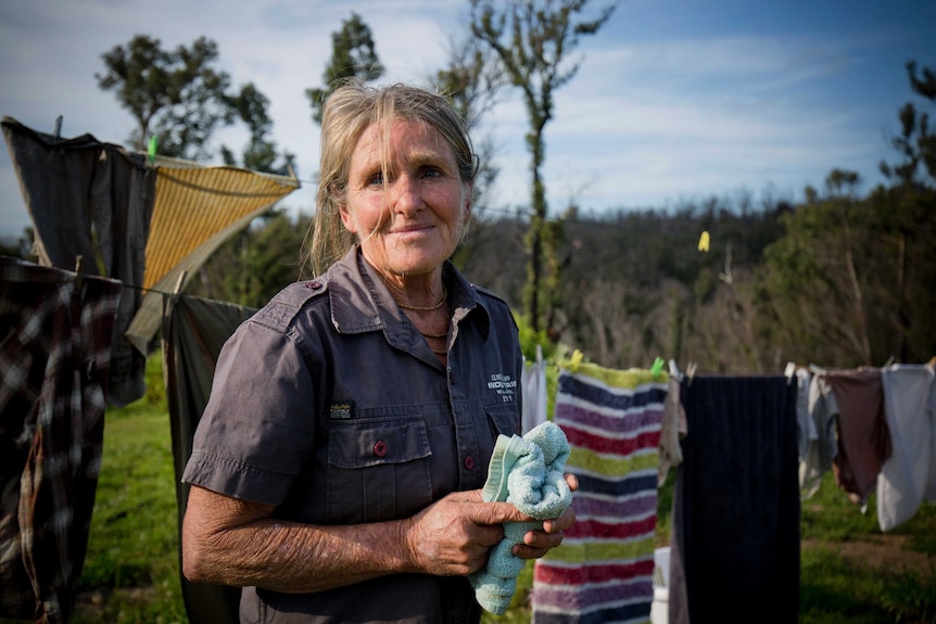 Amanda Heffernan-Buchan looks up while hanging washing on her line.