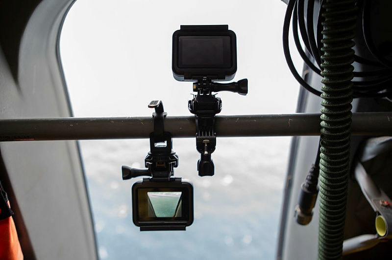 A go-pro camera looks over the ocean from an aircraft