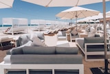luxury beach cabanas and umbrellas at a day club set up on the sand