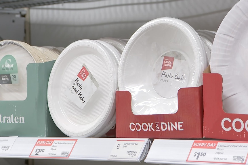 plastic plates on a shelf in a supermarket