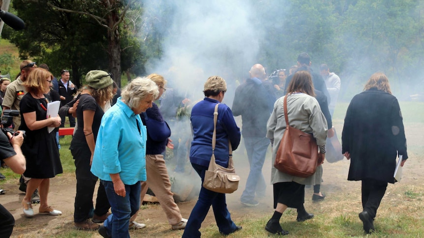 Meeting participants take part in a smoking ceremony at Risdon Cove.