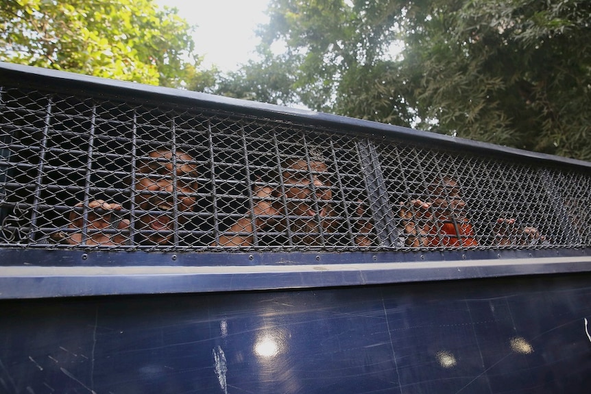 Islamists inside a police van