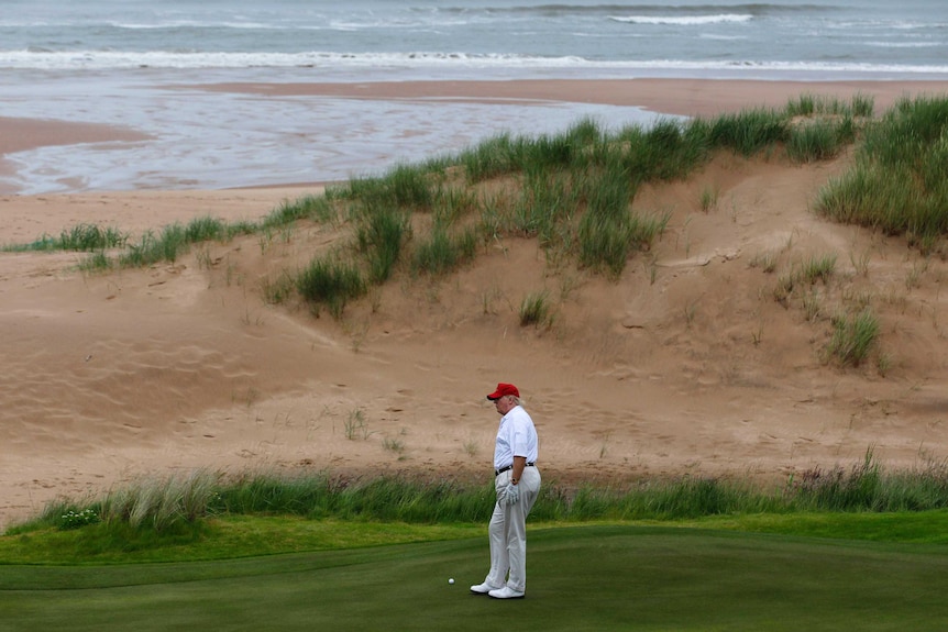 Donald Trump golfs by the sand dunes in Scotland