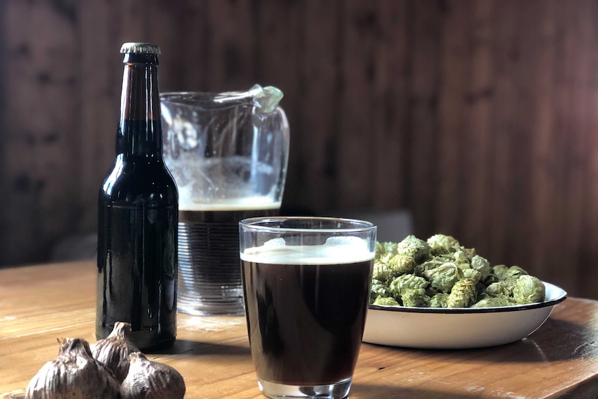 A bottle and jug of garlic beer