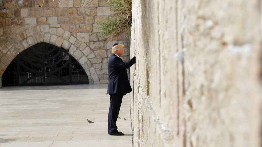 US President Donald Trump touches the Western Wall, Judaism's holiest prayer site.