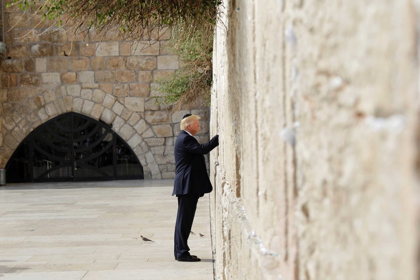 US President Donald Trump touches the Western Wall, Judaism's holiest prayer site.