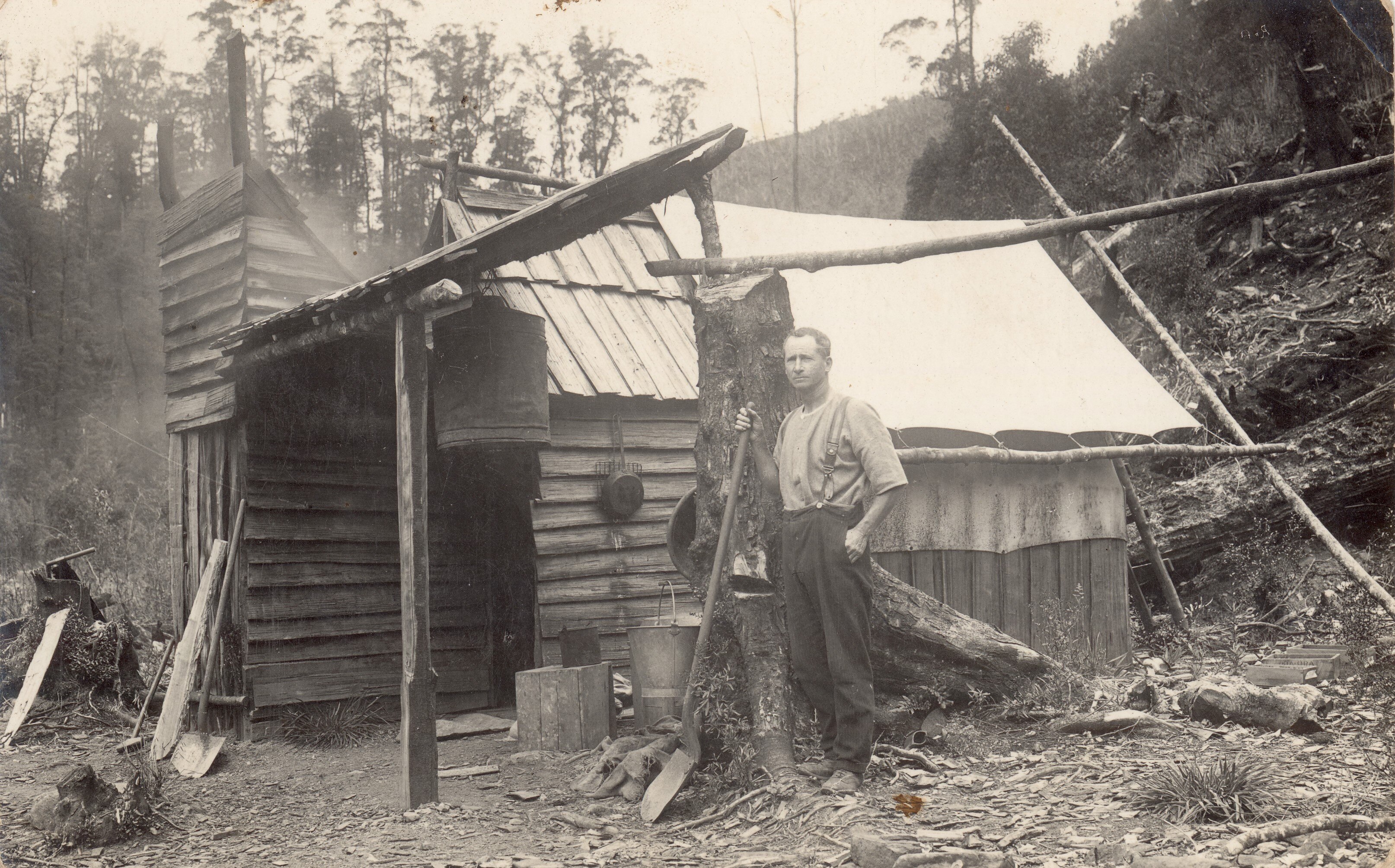 a black and white photo of a miner's hut
