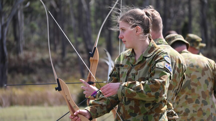 Female cadet firing bow and arrow
