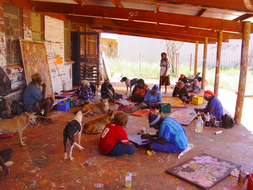Artists painting at Warlukurlangu Artists Aboriginal Art Centre, 2003