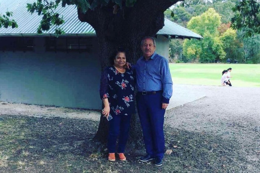 Suad Hirmiz and her husband pose under a tree. 