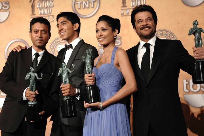 "Members of the cast of Slumdog Millionaire hold up Screen Actors Guild Awards trophies.