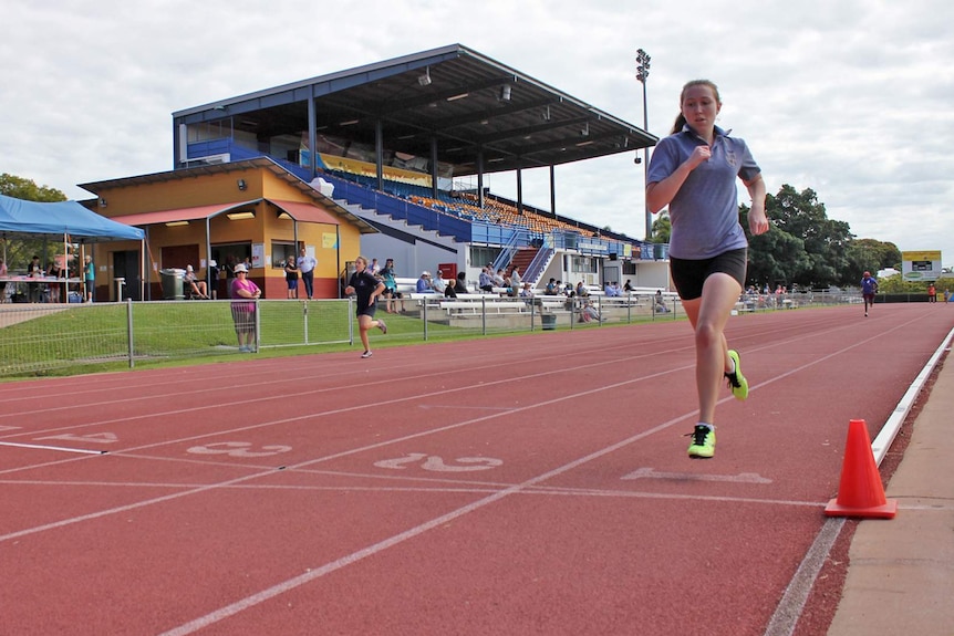 Paralympian Brianna Coop running on an athletics track in Townsville as a student ion 2014.