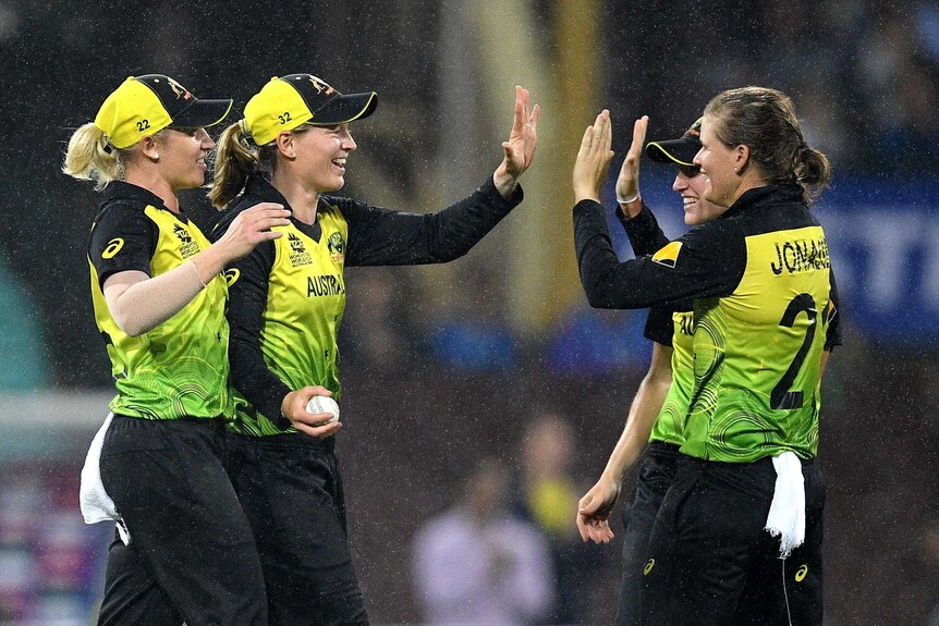 A bowler high fives the fielder who took a catch off her bowling in the T20 World Cup semi.