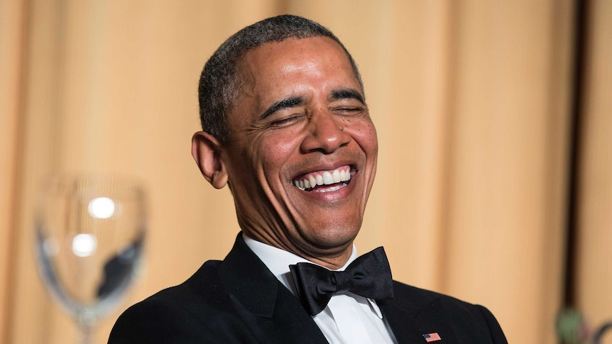 US President Barack Obama laughs at a joke