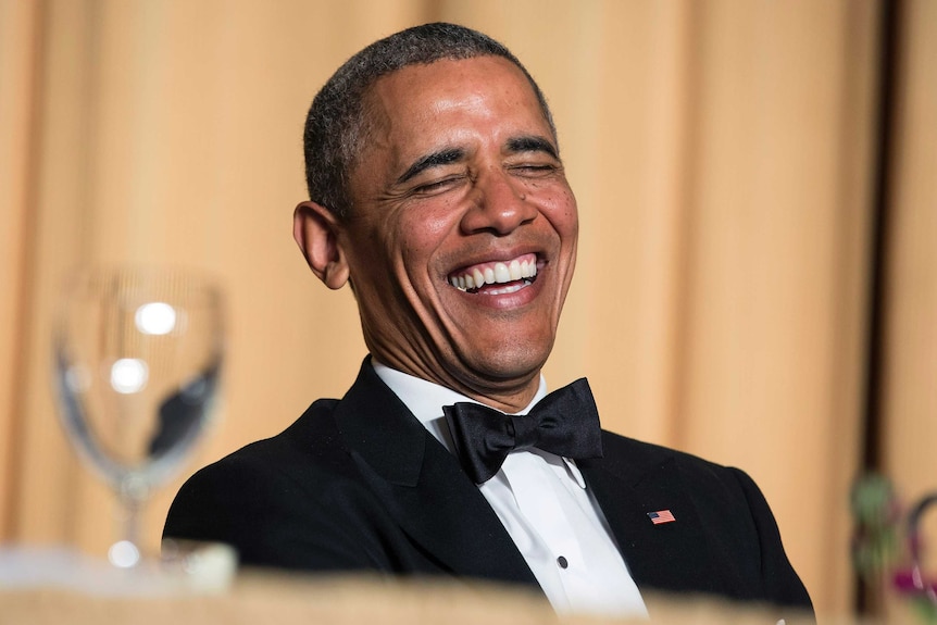 US President Barack Obama laughs at a joke