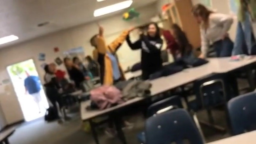 Students flee after a teacher forcibly cuts a student's hair then yells 'next'