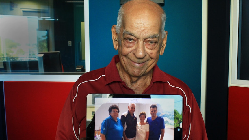 Alf Abdullah holding a photo of his sisters