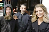 Close up shot of Johnny Bobbitt Jr., left, with a big smile, with Kate McClure, right, and her boyfriend M'Amico in the centre.