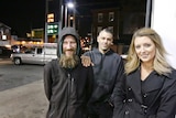 Close up shot of Johnny Bobbitt Jr., left, with a big smile, with Kate McClure, right, and her boyfriend M'Amico in the centre.