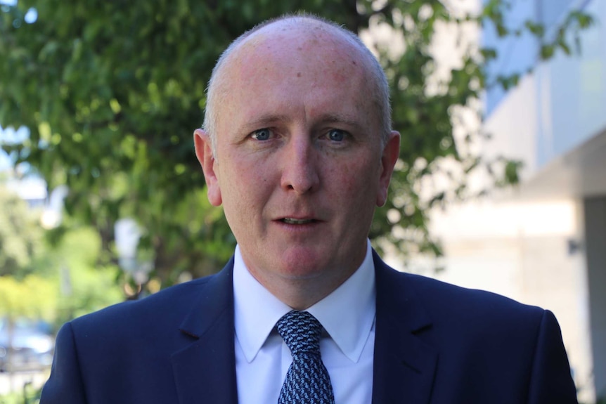 A head and shoulders shot of WA Environment Minister Stephen Dawson wearing a suit and looking at the camera.