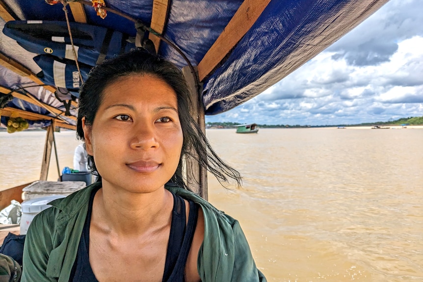 Inga looks out from a boat cruising down Colombia's Amazon