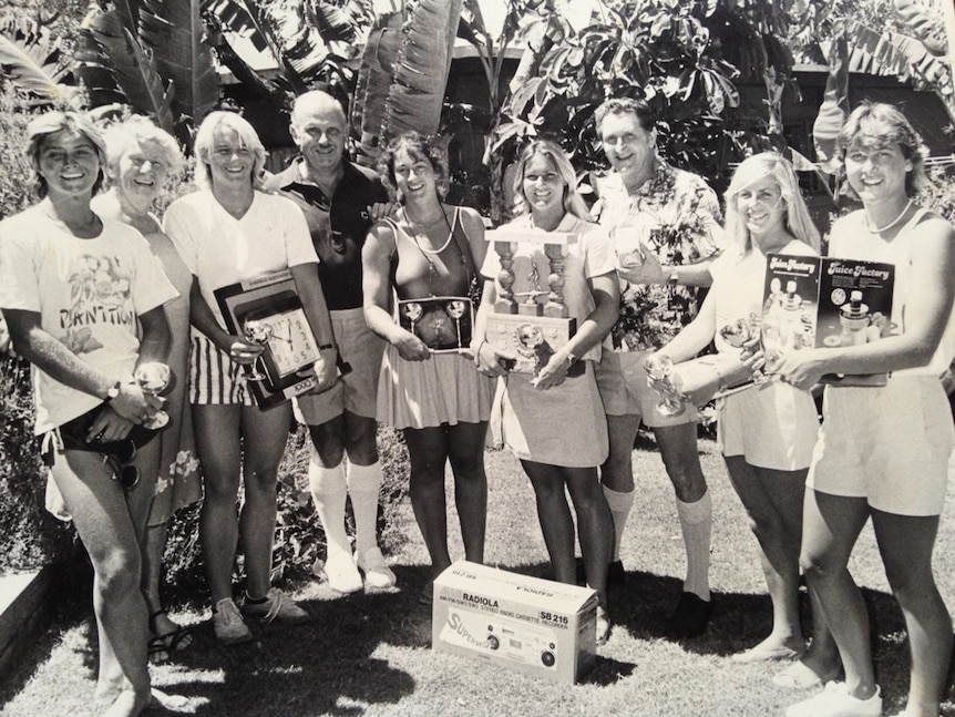 women standing with trophies after a 1983 event.