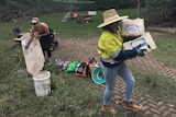 Volunteers part of the "Mud Army" at a Logan property helping to clean up