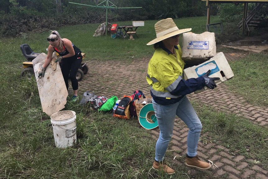 Volunteers part of the "Mud Army" at a Logan property helping to clean up