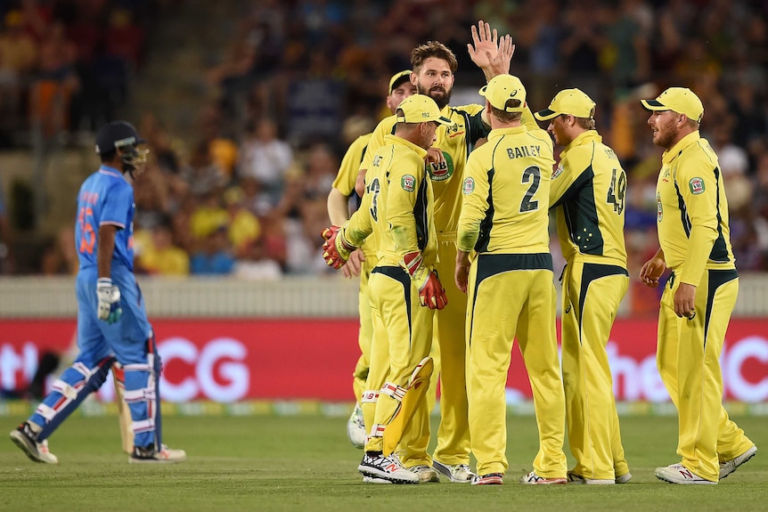Kane Richardson celebrates a wicket as India collapses