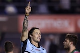 Nicho Hynes points to the sky after Cronulla Sharks' NRL win over South Sydney Rabbitohs.