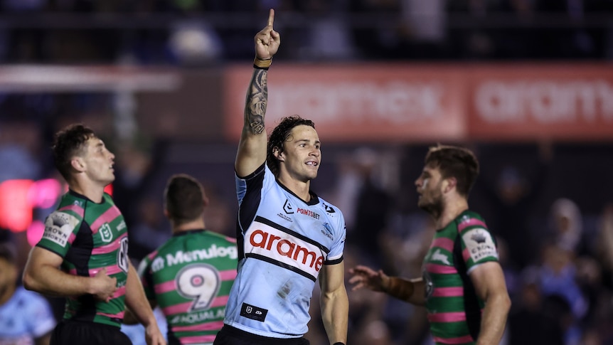 Nicho Hynes points to the sky after Cronulla Sharks' NRL win over South Sydney Rabbitohs.