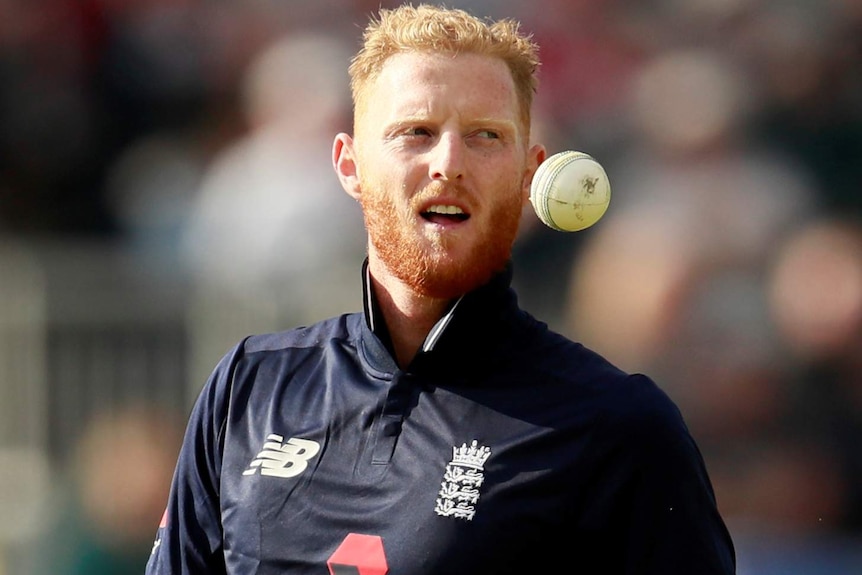 Ben Stokes throws a white ball in the air in a one-day international match.
