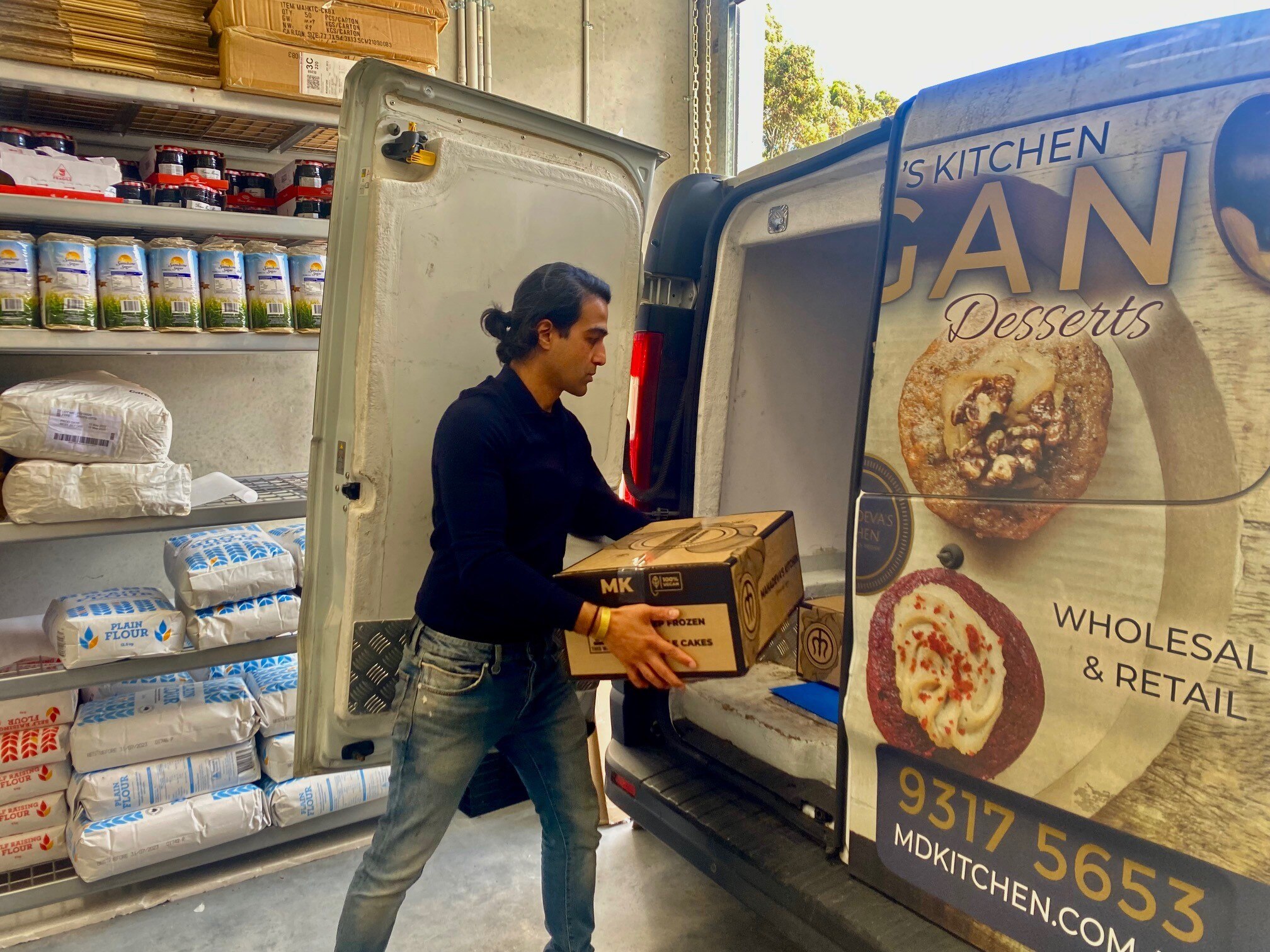 A man puts a box into a van