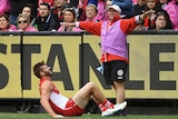 Alex Johnson lies injured on the sideline