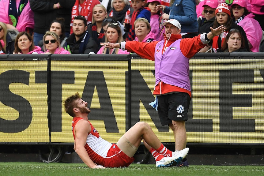 Alex Johnson lies injured on the sideline