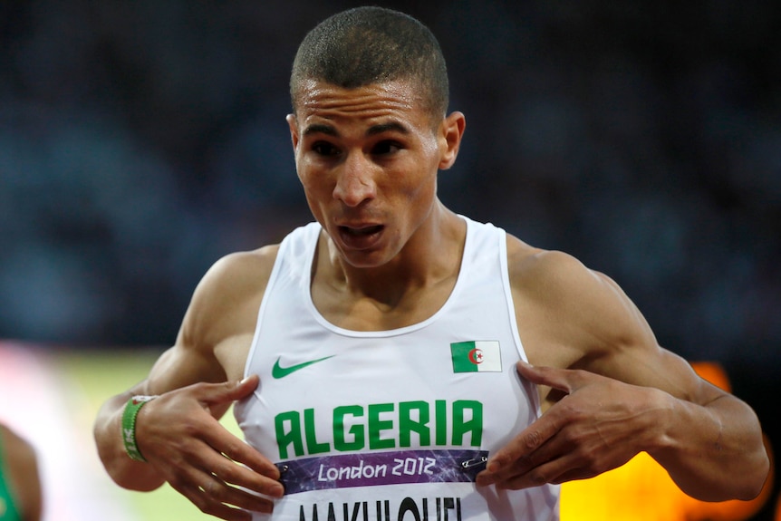 Taoufik Makhloufi celebrates after finishing first in the men's 1500m semi-final.